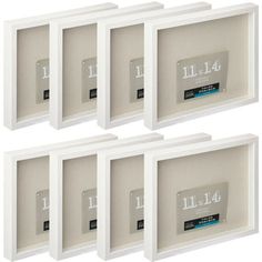 four white frames with numbers and labels on them for display or wall hangings, set of 4