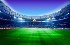 an empty soccer stadium with bright green grass