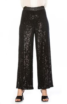 Sparkling sequins bring dazzling allure to a pair of stretch pants that are elevated by a wide leg and mid rise. Banded waist Invisible back zipper 90% polyester, 10% spandex; lining content: 100% polyester Hand wash cold, lay flat to dry Imported Model stats: 5'10", 32" bust, 25" waist, 36" hip. Model is wearing size X-Small. Black Embellished Wide Leg Bottoms, Stretch Bottoms With Contrast Sequin For Night Out, Glamorous Fitted Wide Leg Pants With Sequins, Embellished Straight Evening Bottoms, Glamorous Embellished Black Bottoms, Glamorous Black Embellished Bottoms, Embellished Evening Bottoms For Holidays, Embellished Straight Pants For Evening, Embellished Bottoms For Evening Holiday Events