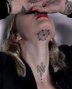 a woman with tattoos on her face and hands