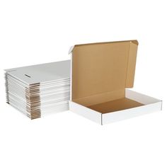 a box filled with lots of white paper next to a stack of cardboard boxes on top of each other