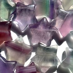 many different colored glass stars are arranged together