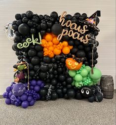 balloons and decorations are arranged in the shape of a halloween scene, with words that spell out boo's pocus