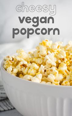 a white bowl filled with cheesey vegan popcorn