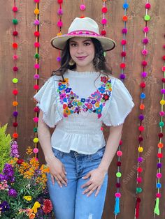 This beautiful Flounce Sleeve Top is the perfect Top for a fun day out or special event. The adorable fluttery sleeves and colorful hand embroidered flowers make it flirty and fun. It's made out of fine Mexican cotton, has an elastic waist and has colorful flowers embroidered completely by hand. This blouse is made with love by Mexican Artisans in Chiapas, Mexico. Please note: This blouse comes in one size which fits sizes Small and Medium. Purchase the Mexican hats here: https://www.etsy.com/es Spring Beach Peasant Top With Multicolor Embroidery, Traditional Embroidered Top For Beach In Spring, White Hippie Peasant Top For Summer, Spring Festive Embroidered Short Sleeve Top, Festive Spring Embroidered Top With Short Sleeves, Festive Embroidered Short Sleeve Top For Spring, Summer Festive Blouse With Floral Embroidery, Bohemian Summer Tops For Festive Occasions, Bohemian Tops For Festive Summer Occasions