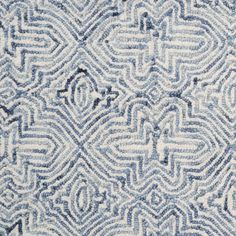 a blue and white rug with an abstract design