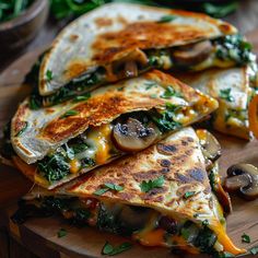 three quesadillas stacked on top of each other with mushrooms, cheese and spinach