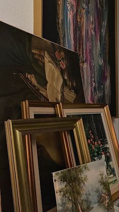 paintings and pictures are on display in a room