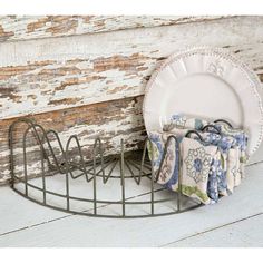 a white plate and some napkins in a holder on a wooden table with words above it