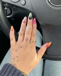 a woman's hand on the steering wheel of a car with stars painted on it