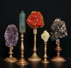 five different types of crystals on gold candlesticks