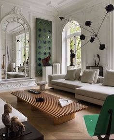 a living room filled with furniture and mirrors