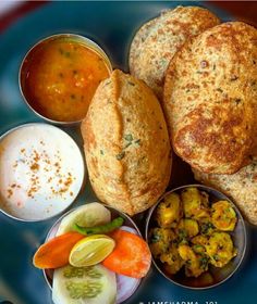 several different types of food on a plate with sauces and condiments in bowls