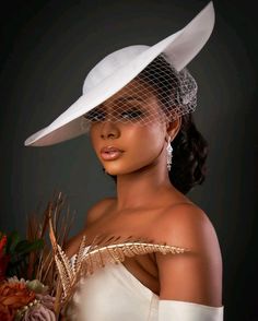 a woman wearing a white hat and veil