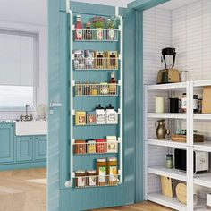 an open pantry door in a kitchen with blue walls and white shelving units on the wall