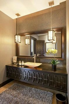 a bathroom with a sink, mirror and rug on the floor