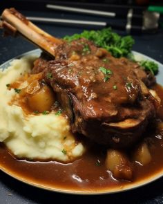 meat and gravy on a plate with mashed potatoes