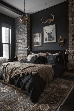 a large bed in a bedroom next to a brick wall with pictures on the wall