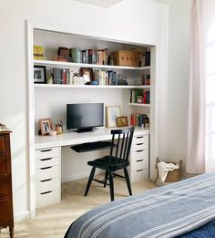 a bedroom with a bed, desk and bookshelf in the corner is shown