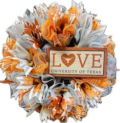 an orange and white wreath with the word love on it