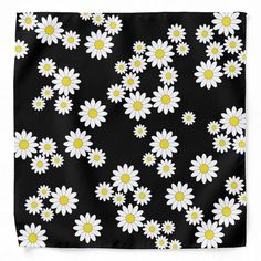 a black background with white and yellow daisies