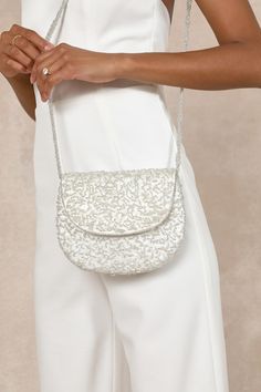 Step out looking ever so luxe with the Lulus Glittery Babe Ivory and Silver Beaded Pearl Crossbody Bag! Sleek woven satin boasts an allover design of textured silver beading, clear sequins, and faux pearl details. Rounded silhouette boasts a foldover top flap that has a magnetic closure and opens to reveal a roomy interior with a sidewall pocket. Intricately beaded crossbody strap completes the look. Lined. Bag Measures 7. 5" Wide, 6" Tall, And . 5" Deep. 45" Silver Chain Strap. Strap Has A 20" White Embellished Clutch Bag, White Evening Crossbody Bag, White Crossbody Evening Bag For Formal Occasions, White Crossbody Evening Bag For Formal Events, Evening White Crossbody Bag, Luxury Embellished Cream Bags, Luxury Embellished White Bags, Luxury White Embellished Bags, Luxury White Embellished Bag