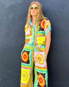 Get ready to stop traffic with this fabulous, conversation starting, compliment demanding button front blouse. Featuring a groovy, 60's inspired all-over print placement sunflower pattern, these vibrant pants are perfect for all of your fabulous festivities. With a relaxed, loose fit, these elastic waist pants are stylish and ultra comfortable. The drawstrings feature colorful beads for a dramatic touch. The roomy side seam pockets are perfect for carrying all your essentials and make these pant Sunflower Pattern, Border Print, Print Placement, African Safari, Elastic Waist Pants, Spiritual Jewelry, Party Girls, Waist Pants, Aphrodite