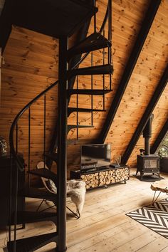 a living room filled with furniture and a spiral staircase