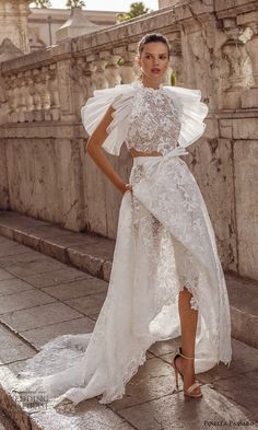 a woman in a white dress standing on steps