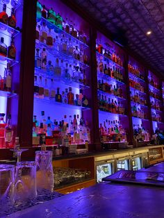 the bar is filled with many bottles of liquor