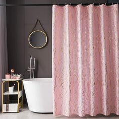 a pink shower curtain in a bathroom next to a bathtub and sink with a mirror on the wall