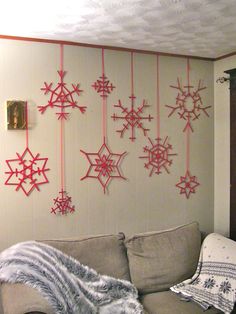 a living room filled with furniture covered in snowflakes hanging from the ceiling above