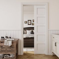 an open door leading to a bedroom with white walls