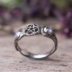 "This dainty witchy ring, made of sterling silver and two rainbow moonstone gemstones on the sides of the moons. Triple moon ring - The triple moon symbol shows the waxing, full and waning moon of feminine energy through all phases of life -- Maiden, Mother and Crone. The five points of the pentagram represent fire, water, air, earth and spirit. Magick jewelry. Measurements and details: * The ring was made in the lost wax technique, it was hand carved in wax and was casted in silver. * Size: The Magical Silver Jewelry With Sun And Moon Design, Mystical Moonstone Promise Ring, Magical Silver Moon Phase Jewelry, Mystical Sterling Silver Moonstone Ring With Moon Phase, Magical Sterling Silver Moon Phase Jewelry, Magical Silver Sterling Silver Moonstone Ring, Magical Silver Moonstone Ring, Magical Sterling Silver Moonstone Ring, Magical Moonstone Sterling Silver Ring