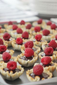 raspberry and chocolate cups on a baking sheet