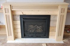 a fire place in a room with no one around it and wood planks on the floor