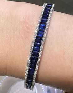 Bangles are great for stacking, but with this bold and beautiful blue sapphire & diamond bangle bracelet, you only need one!Metal: 18K White Gold Sapphire Weight: (33) 5.94ct twDiamond Shape , Weight: (134) Round Brilliant-cuts 0.50ct t.w.Bangle/Wrist Width: 57mm x 48cmBangle Weight: 8mm Expensive Bracelets, Emerald Bangles, Sapphire Bangle, Blue Sapphire Bracelet, Blue Sapphire Jewelry, White Gold Bangle, Diamond Bangle Bracelet, Award Ceremony, Ruby Bracelet