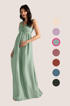 a pregnant woman in a green dress with her hands on her belly, standing next to color swatches