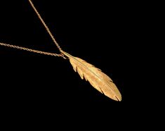 Large 14k Yellow Gold Raven Feather Pendant or Necklace. The feather is solid 14k yellow gold and is fully 3 dimensional. It measure approximatley 51mm or 2 inches long and 13mm wide. This pendant is also available with an 18, 20 or 24 inch 1.75mm 14k yellow gold cable link chain. This feather pendant was handmade and hand finished by Daniel Leslie and is his original design. ASK ABOUT CUSTOMIZATION: This Item along with most of my other pieces of jewelry can be customized in terms of metal type Gold Feather Necklace Perfect For Gifting, Gold Feather Necklace For Gift, Gold Necklace With Feathers As A Gift, Gold Necklace With Feathers For Gift, Sparrow Jewelry, Man Reference, Gold Feather Necklace, Raven Feather, Yellow Feathers