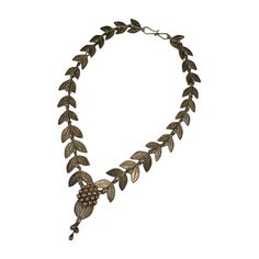 This sterling necklace of laurel leaves and berries is based on a suite of jewelry produced by Italian jeweler Carlo Guiliano circa 1863 in the classical taste. The original suite is in high carat gold as a parure with tiara, necklace, bracelet and earrings. Perfect for Aesthetic devotees of 19th Century society. This 20th Century reproduction is beautifully made in gilt silver with English makers marks. Beautiful quality. UK 1970's. 20 inch". Widest link 1 ", Drop 2.75. Excellent condition. Ornate Formal Necklace With Oxidized Finish, Elegant Bronze Necklace For Ceremonial Use, Elegant Antique Gold Ceremonial Necklace, Elegant Engraved Temple Necklace For Ceremonial Use, Elegant Engraved Temple Necklace For Ceremonial Occasions, Elegant Antique Gold Temple Necklace For Ceremonial Occasions, Elegant Engraved Temple Necklace For Festive Occasions, Moonstone Necklace Silver, Edwardian Necklace