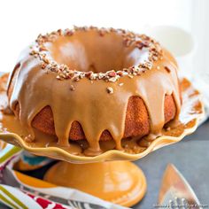 a bundt cake with frosting and nuts on top