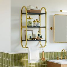 a bathroom with green tile and gold fixtures