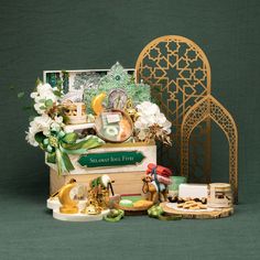 an assortment of items displayed on a green background with a gold arch in the background