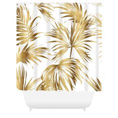 a white shower curtain with gold palm leaves on the outside, and a white tub in front