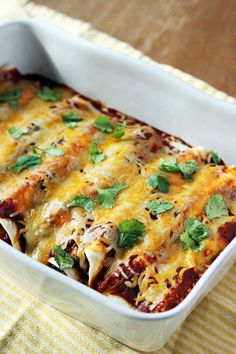 a casserole dish with meat, cheese and cilantro