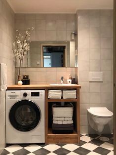 a washer and dryer in a bathroom with checkered flooring on the floor