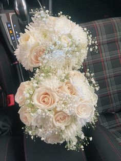 two bouquets of flowers sitting in the back seat of a car