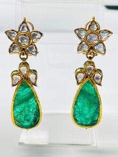 These gorgeous and one of a kind carved and diamond earrings are beautifully handmade in yellow gold.  The details are as follows :  Emerald weight : 50 carats approximately   Diamond weight : 2.50 carats  Gold : yellow gold  Gross weight : 38.16 grams Luxury Carved Earrings For Formal Occasions, Luxury Carved Earrings, Elegant Carved Earrings For Formal Occasions, Luxury Earrings With Intricate Design, Elegant Carved Drop Earrings, Elegant Round Carved Earrings, Carved Diamond Fine Jewelry, Fine Carved Diamond Jewelry, Elegant Carved Round Earrings