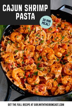 cajun shrimp pasta in a skillet with text overlay