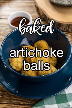 baked artichoke balls in a blue bowl with the words baked artichoke balls